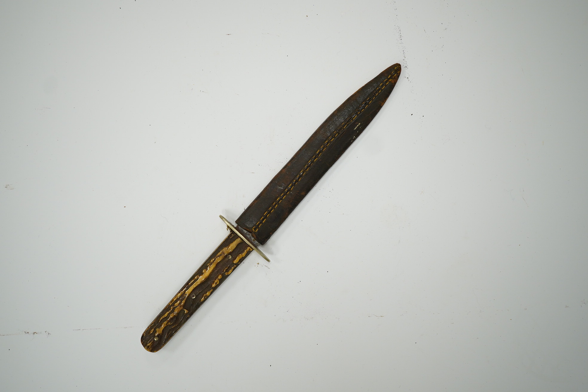 A Hunter of Sheffield, ‘Bugle Knife’ with horn grips, in its leather sheath, blade 15cm. Condition - fair